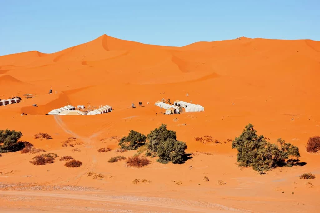 Panoramic sunset view of giant golden sand dunes in Merzouga Erg Chebbi